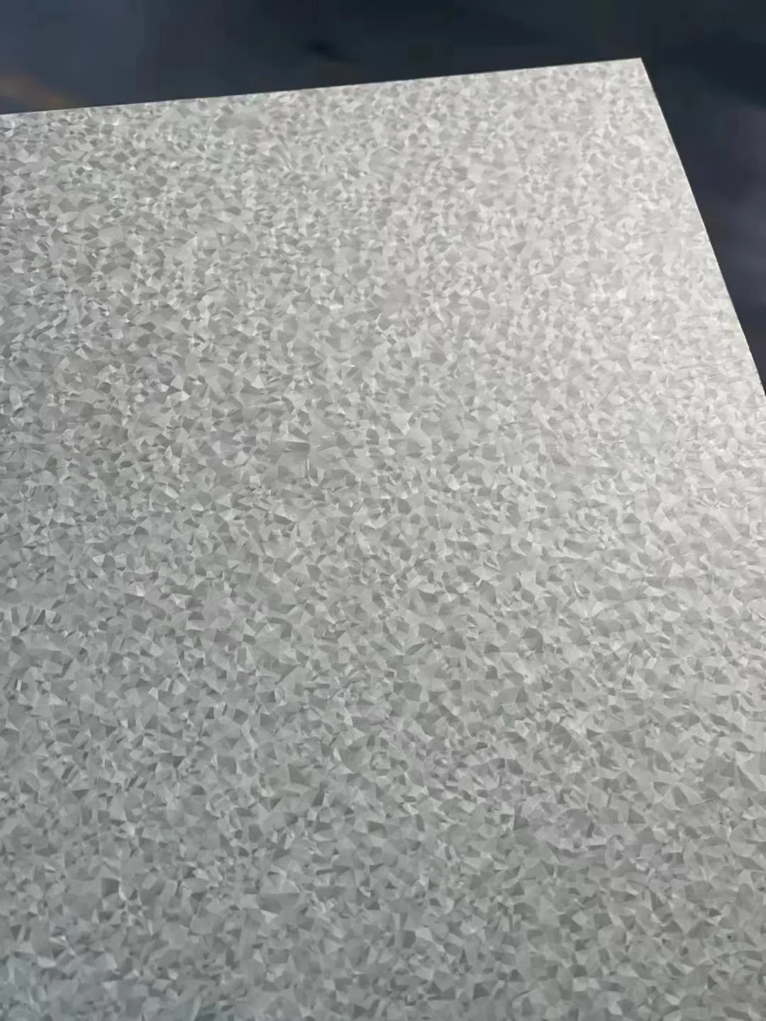 Close up of galvalume steel coil surface showing bright metallic spangle and uniform Aluzinc coating